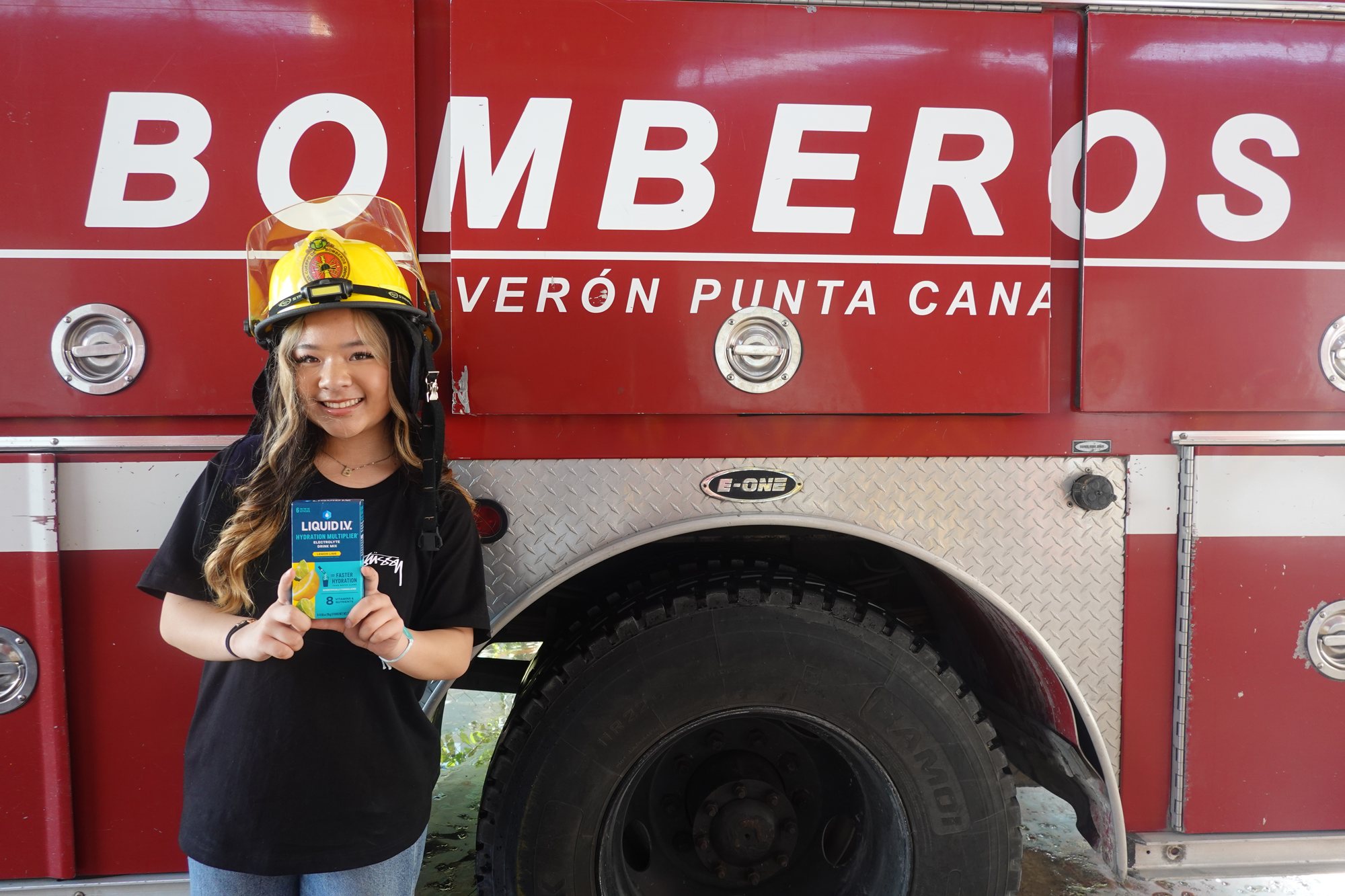 Project Pulmonary student wearing a firefighter helmet at a Dominican Republic fire station