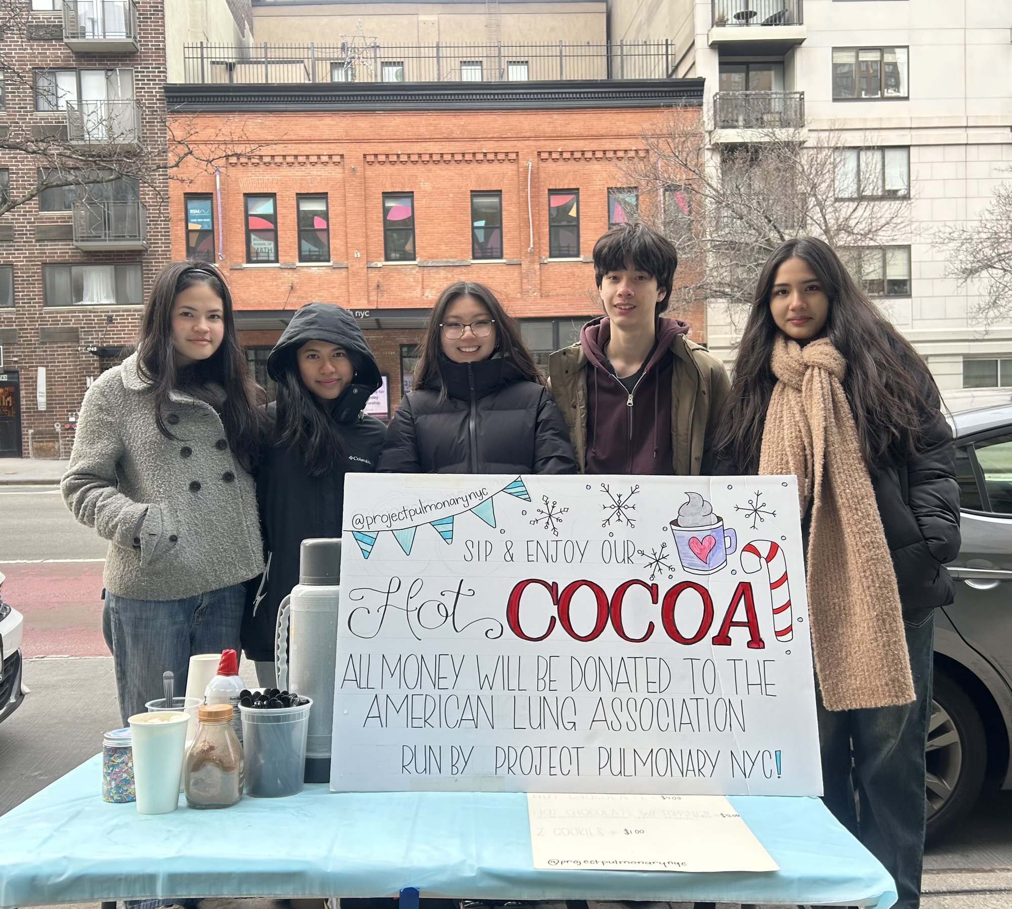 Project Pulmonary NYC students at a hot cocoa fundraiser table