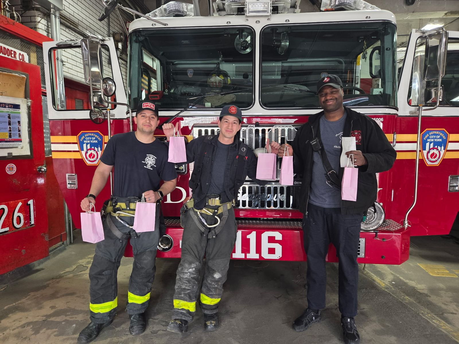 FDNY Ladder 116 firefighters holding Project Pulmonary gift bags