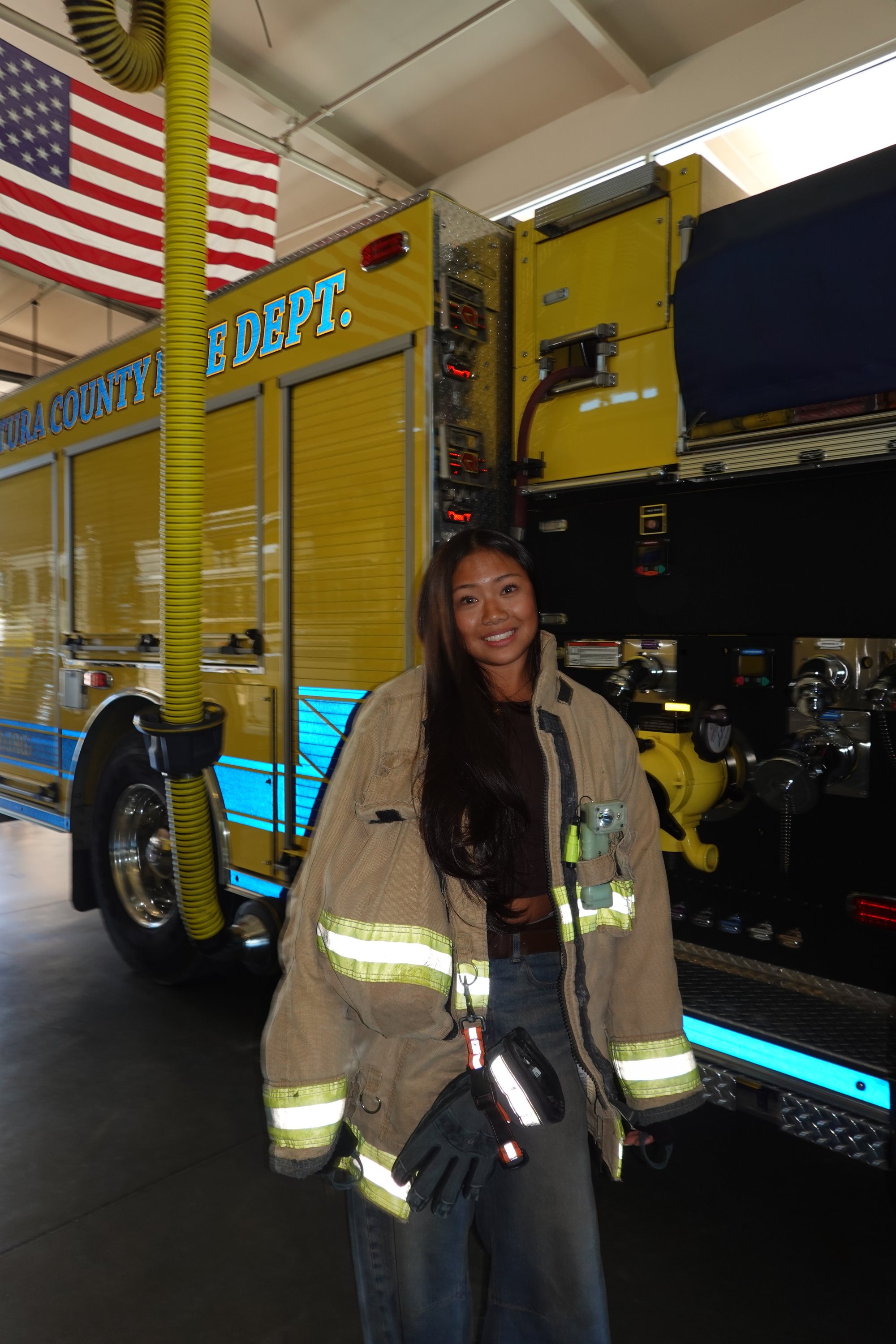 Project Pulmonary student in a firefighter jacket beside a Ventura County fire truck