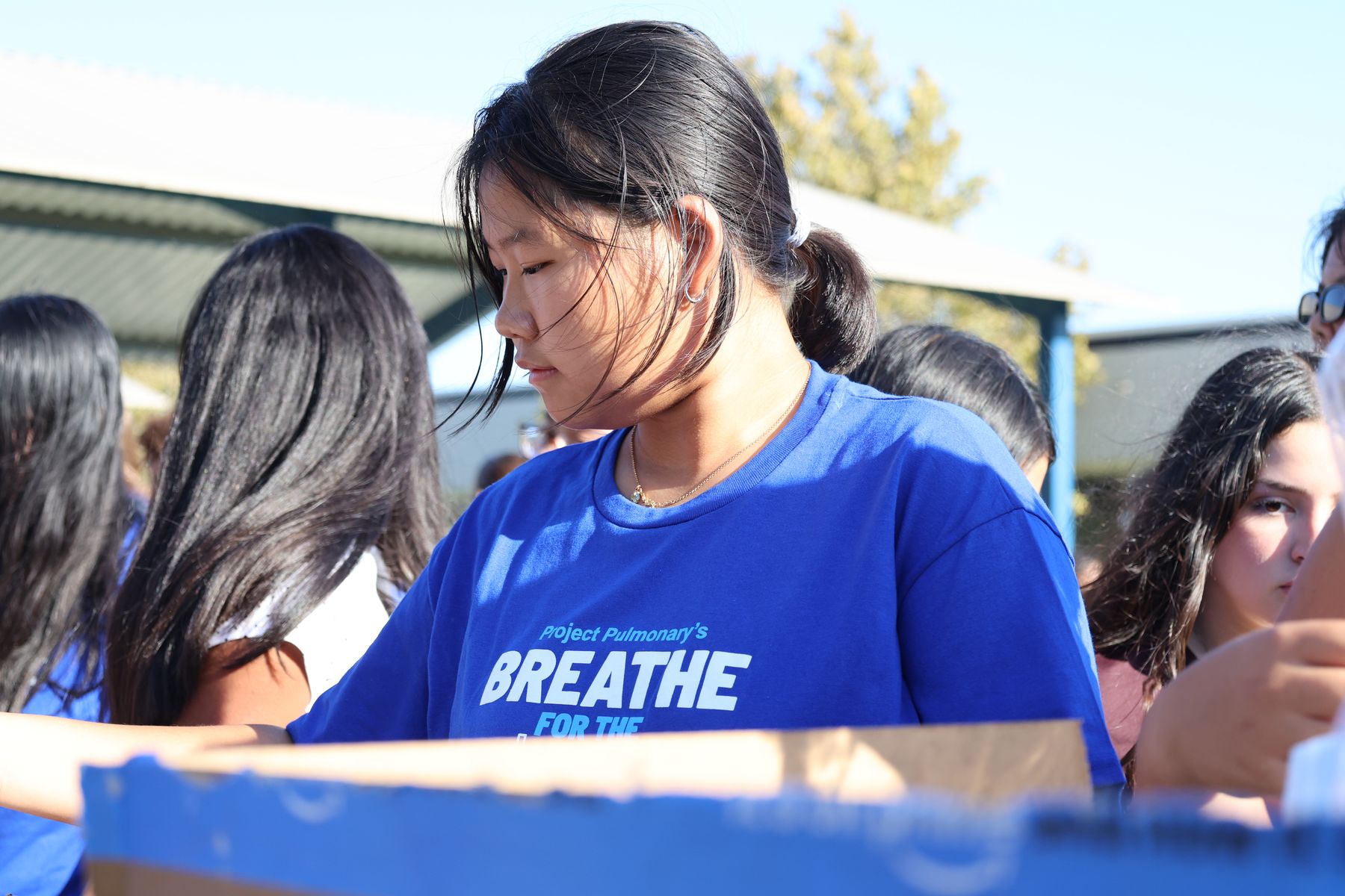 Volunteers assembling kits from boxes