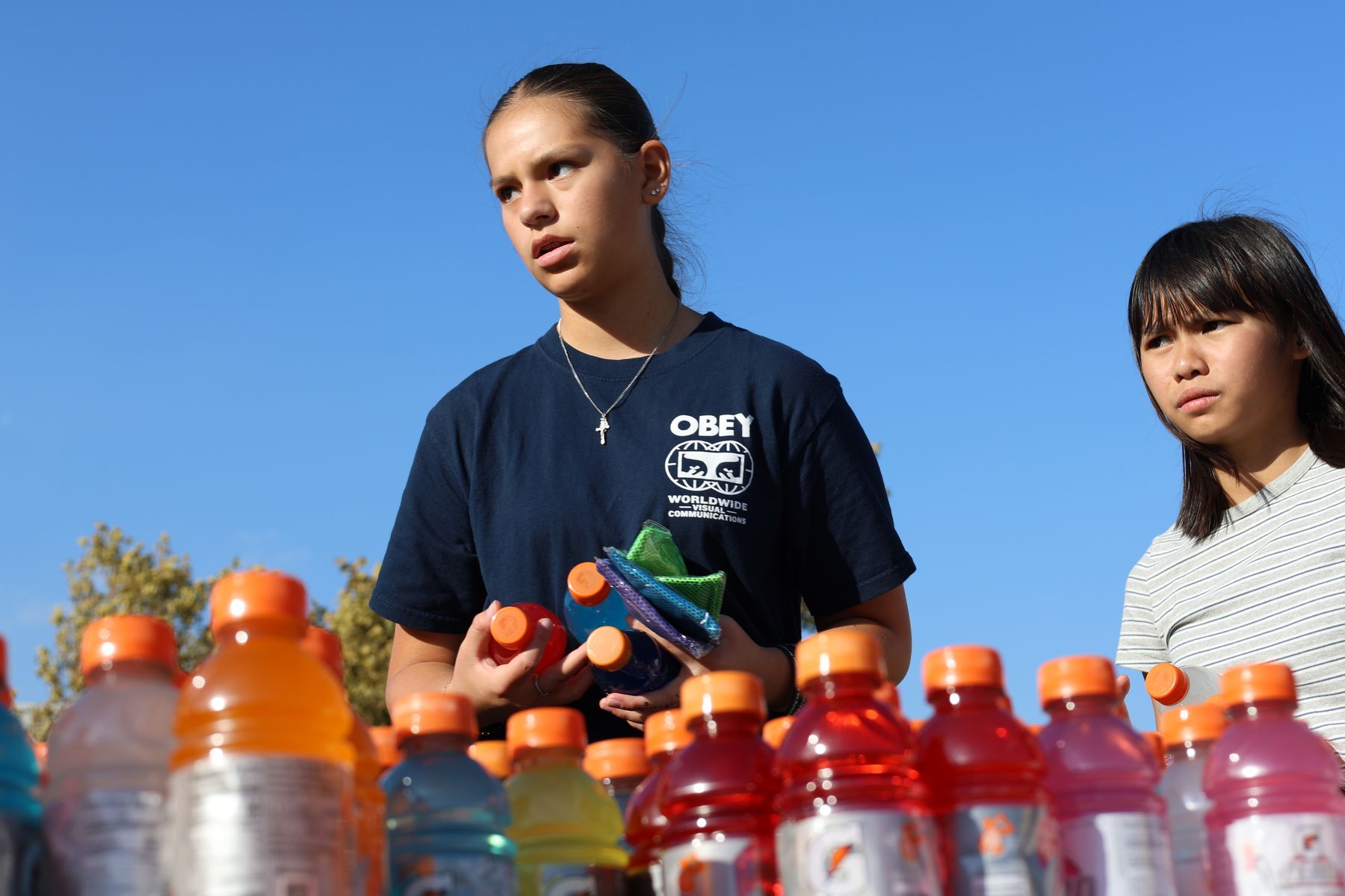 A volunteer sorting sports drinks