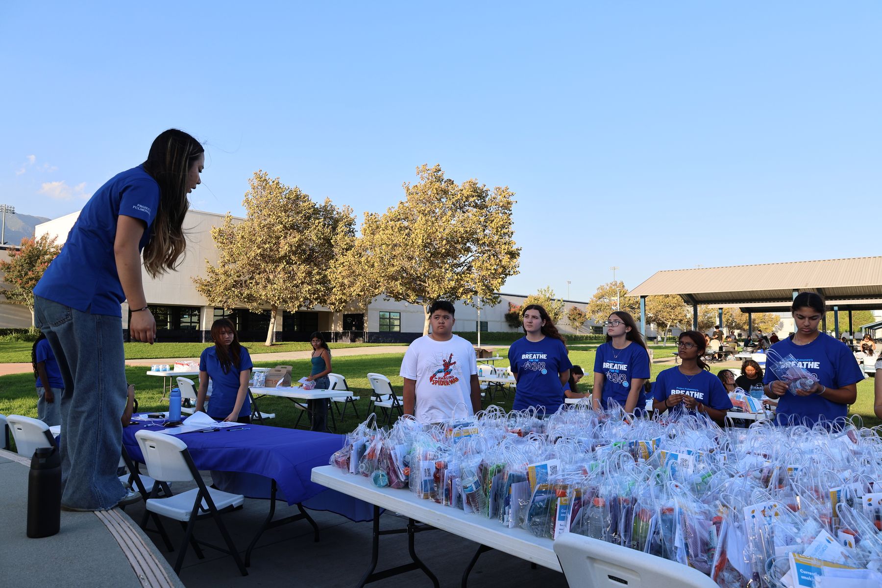 Long tables lined with finished hydration kits and volunteers