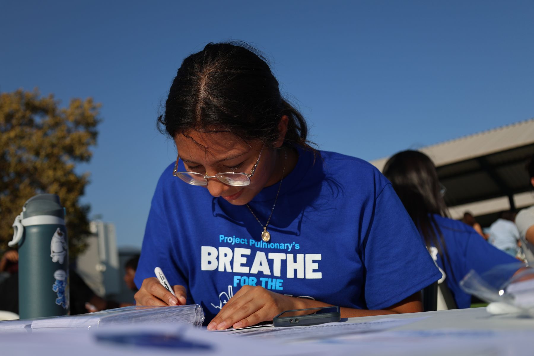 A volunteer writing a note for a firefighter