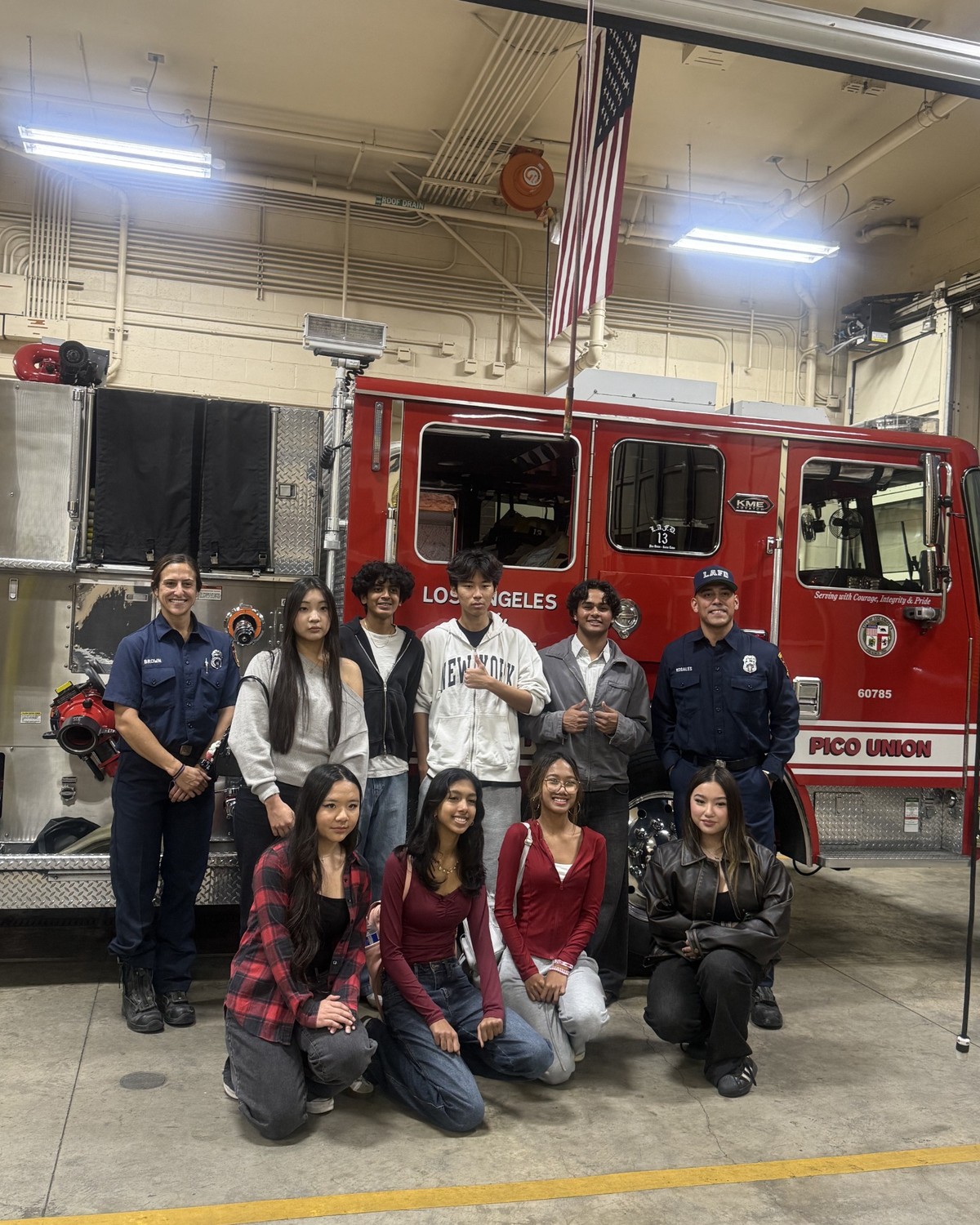 Project Pulmonary students and firefighters standing in front of a fire truck