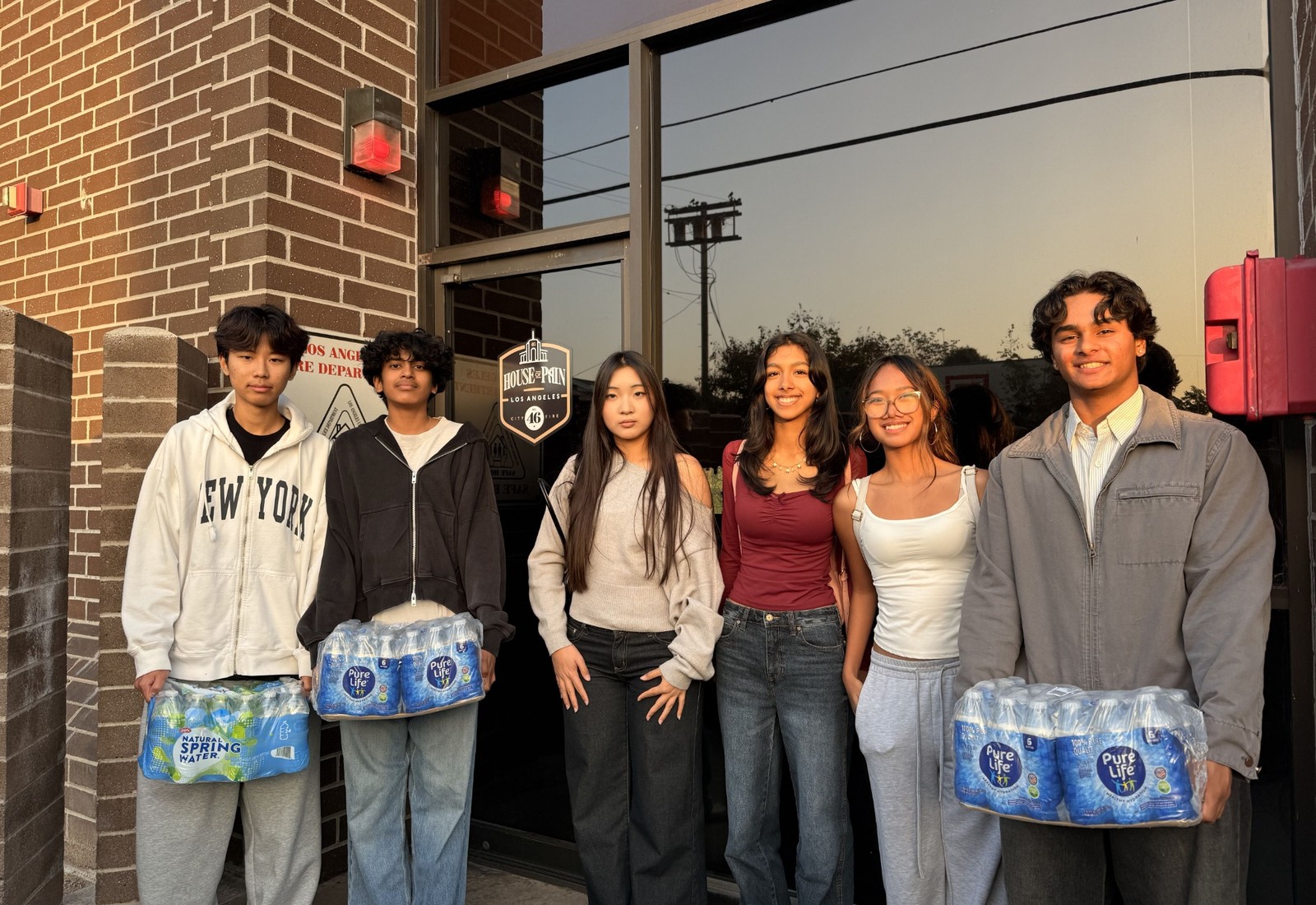 Project Pulmonary volunteers and firefighters holding hydration donations