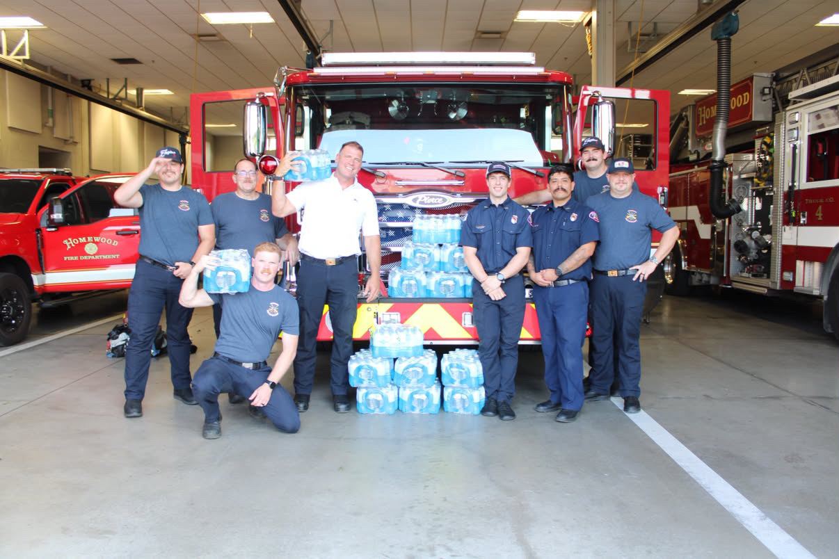 Homewood Fire Department firefighters with donated water cases