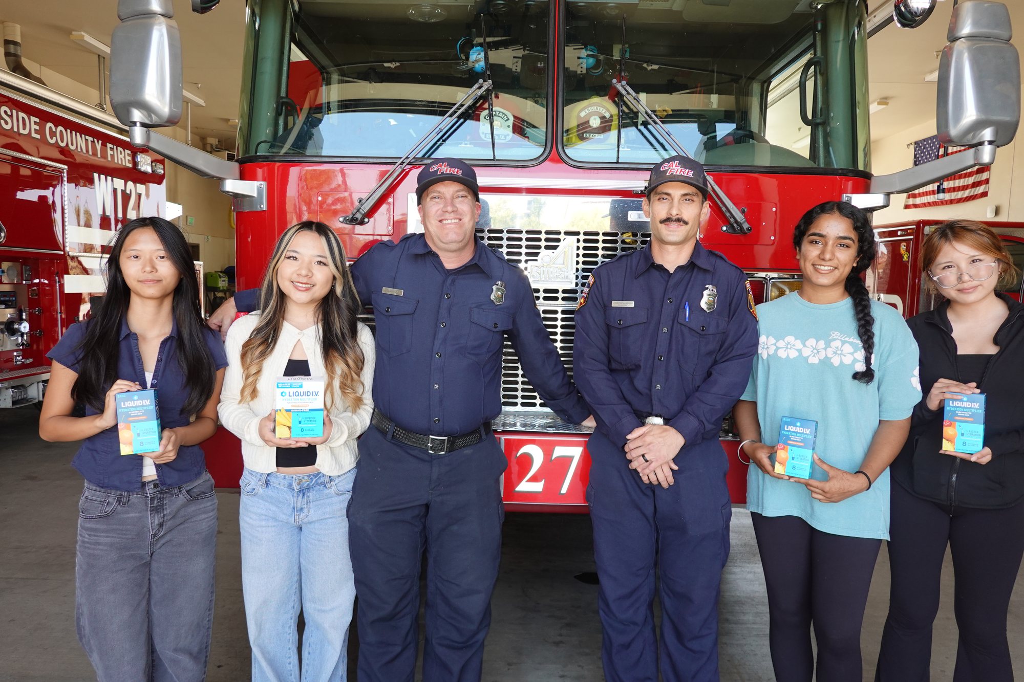 Project Pulmonary students with Riverside County firefighters holding Liquid I.V. donations