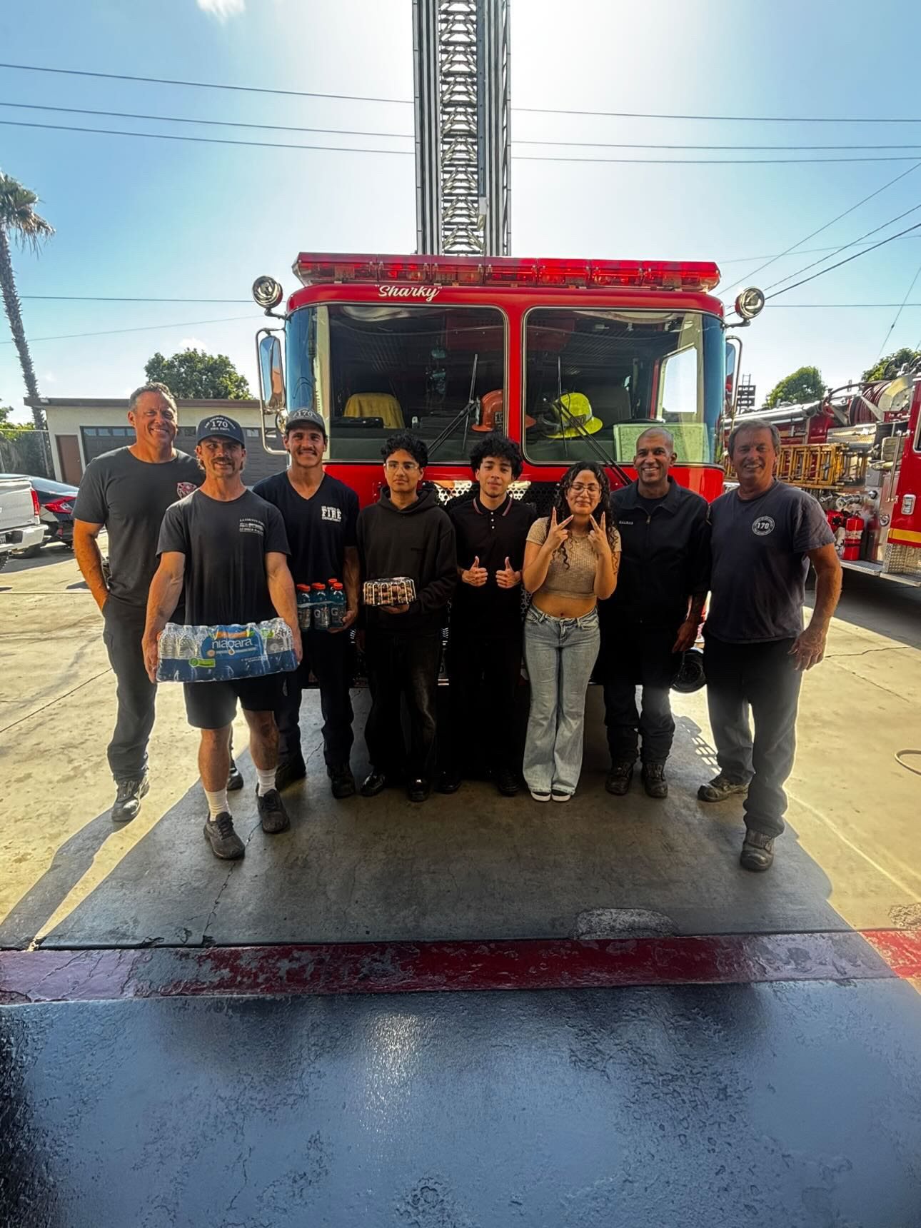 Project Pulmonary students and firefighters with a ladder truck and hydration donations