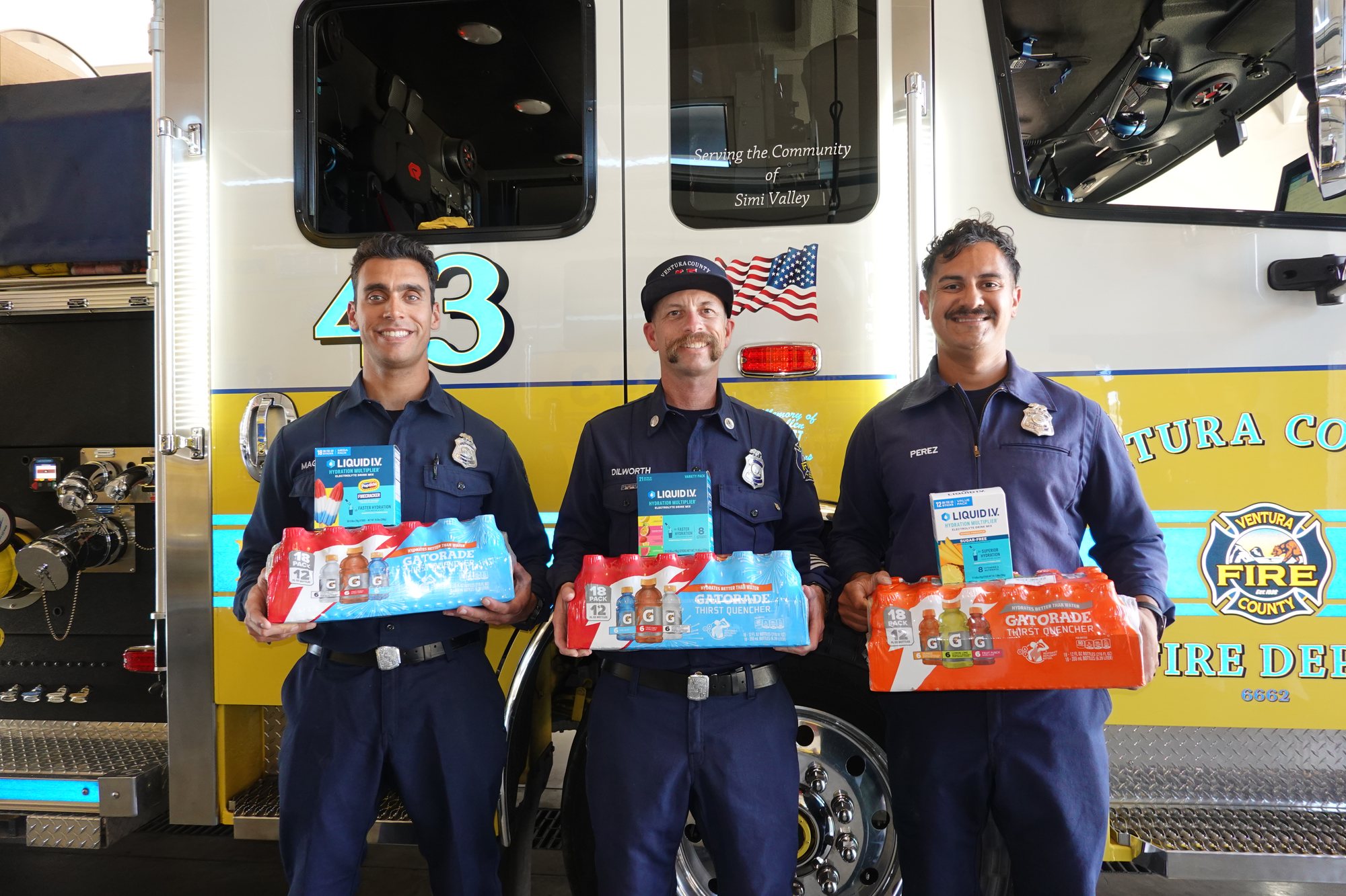 Ventura County firefighters holding hydration donation packs