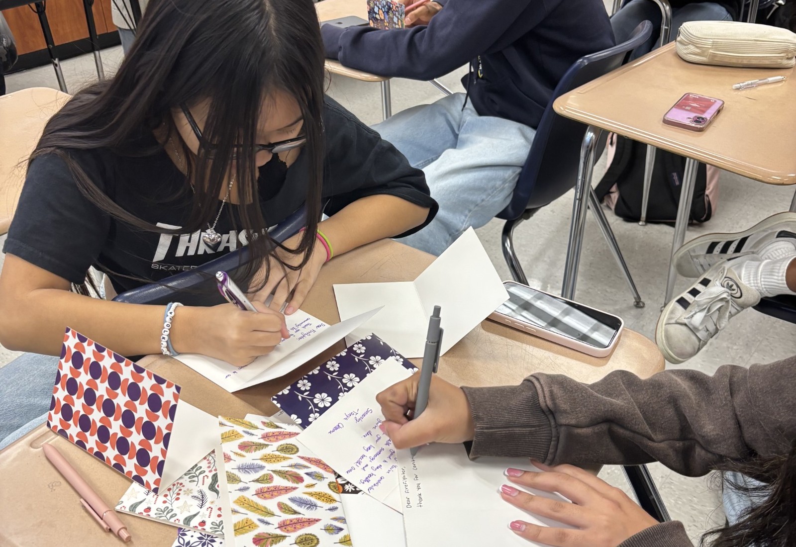 Students writing Letters for Lungs cards in a classroom