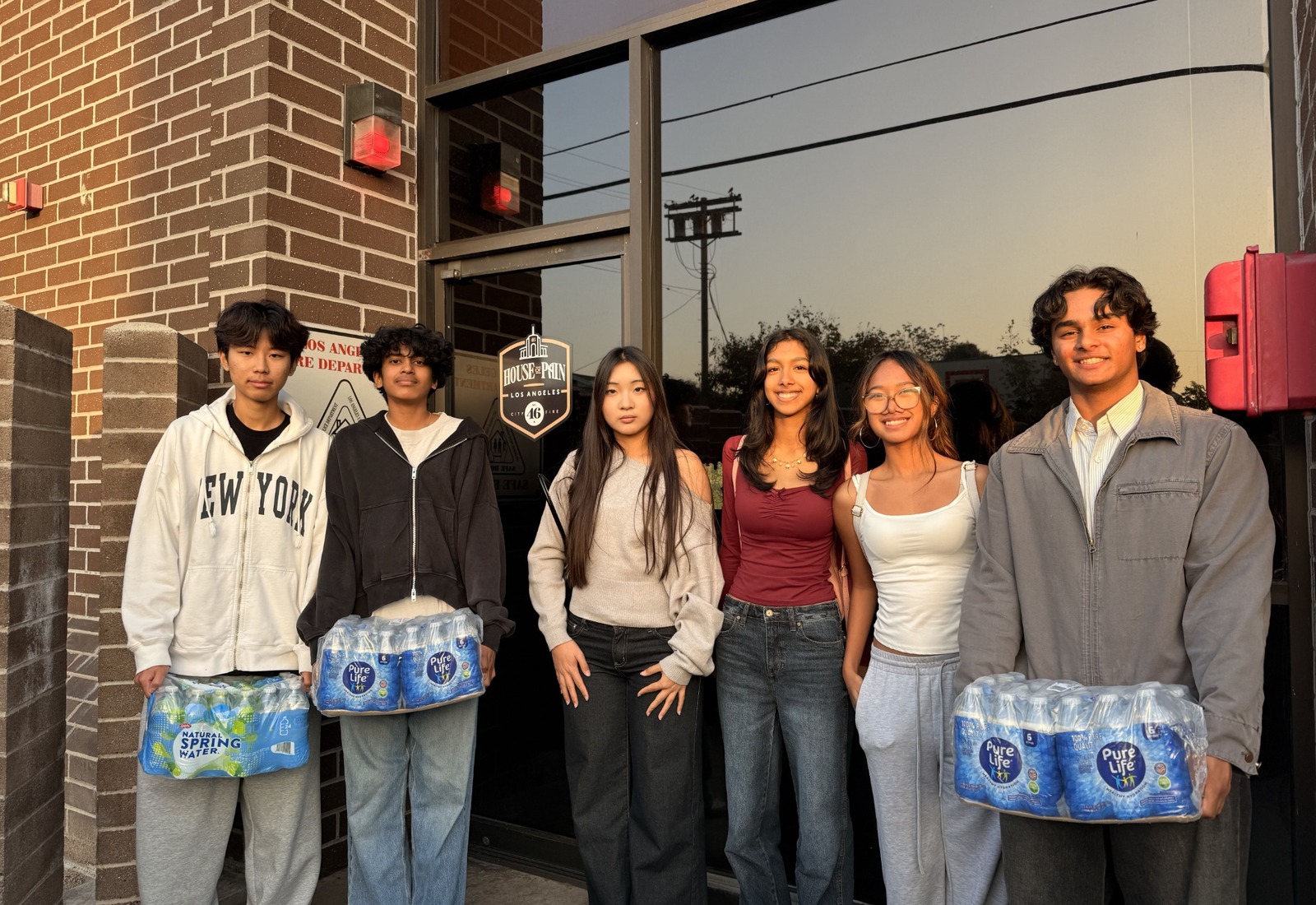 Students holding letters they created for firefighters