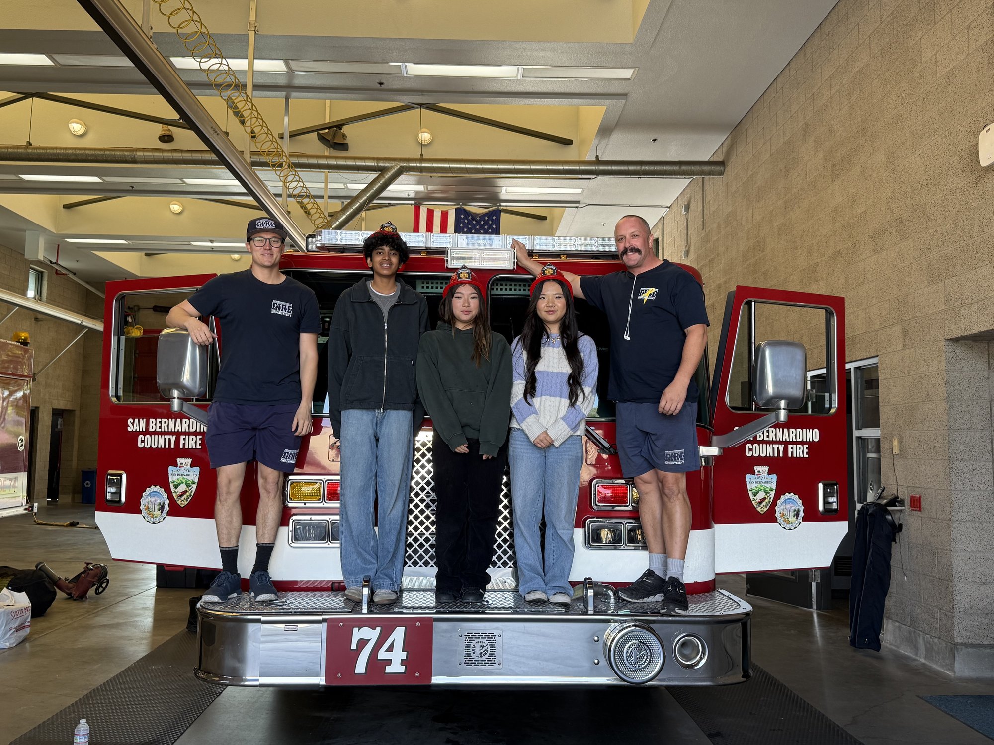 Project Pulmonary students standing on a fire truck bumper