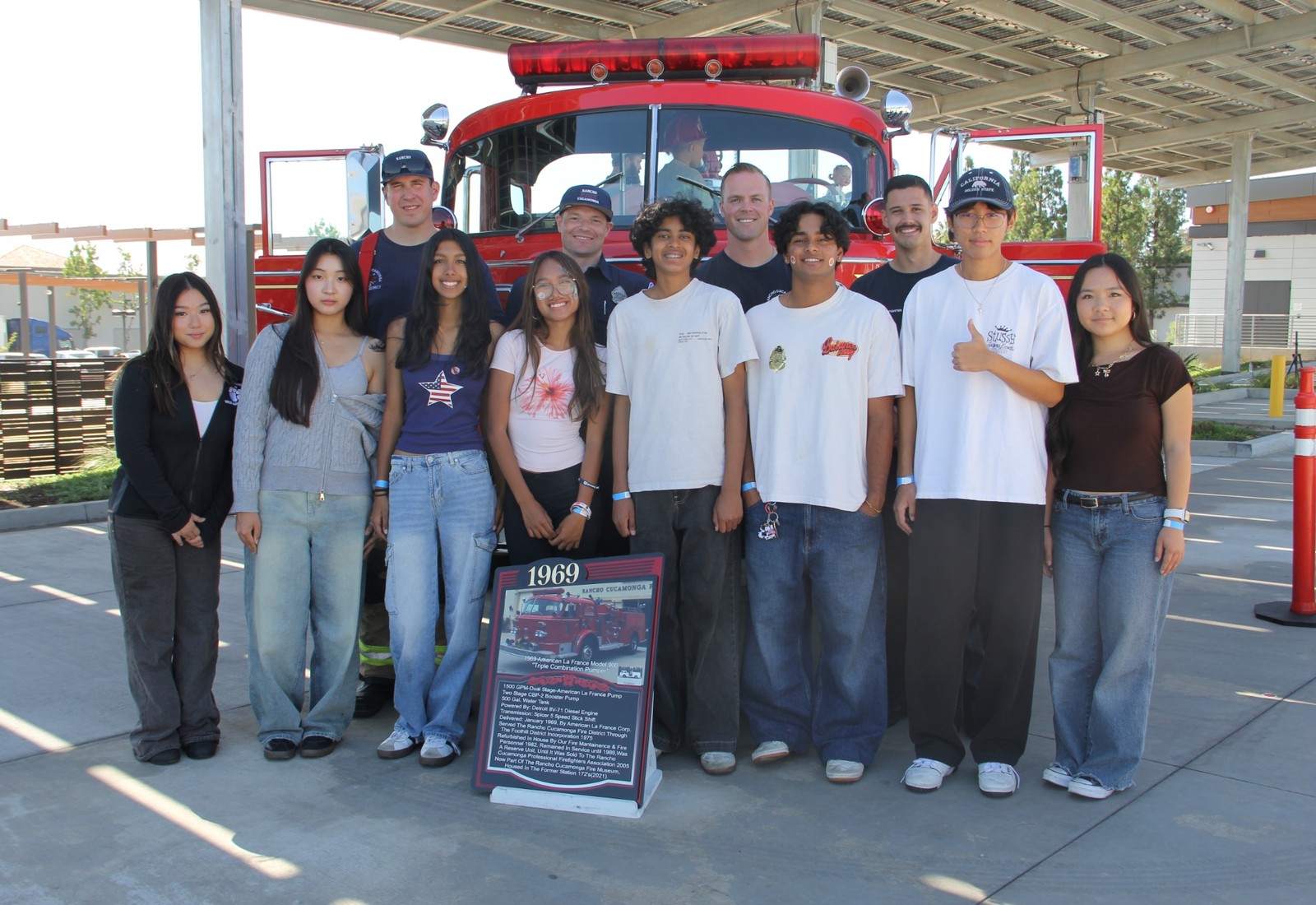 Project Pulmonary students and firefighters in front of a vintage fire truck
